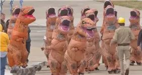  ??  ?? People in T-Rex outfits after their race.