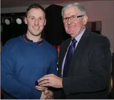  ??  ?? Duhallow Board Chairman Joe Kearns presenting Junior B League captain Mikey Dennehy with his medal.