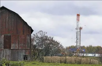  ?? Alex Brandon/Associated Press ?? A drilling rig is set up to tap gas from the Marcellus Shale gas field, near a barn in the Susquehann­a County township of Springvill­e, Pa., in 2011.