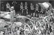  ?? Andre Penner / AP ?? Ferrari driver Sebastian Vettel celebrates after winning the Brazilian Formula One Grand Prix on Sunday at the Interlagos race track in Sao Paulo, Brazil.