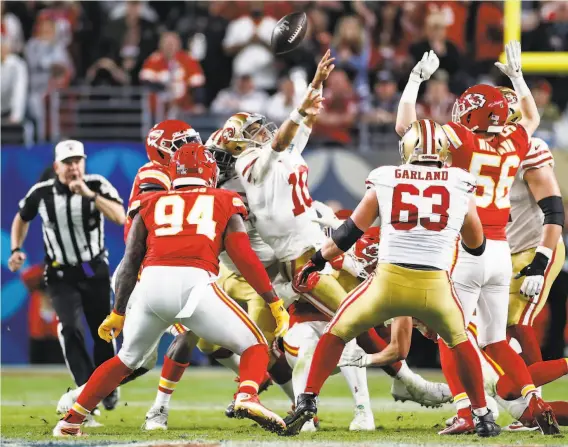  ?? Photos by Scott Strazzante / The Chronicle ?? Jimmy Garoppolo tries to throw a fourthdown pass in the fourth quarter. The play was ruled a sack, and the Chiefs scored a touchdown two plays later.