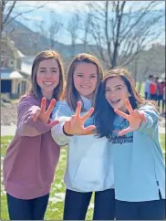  ?? Emily Keller ?? Allison King (from left), Elizabeth Richie and Kate Scott mug for the camera during a Young Life trip to Sharptop Grove in Jasper.