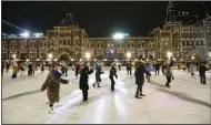  ?? (AP) ?? People enjoy skating on the ice rink opened on Red Square, with the GUM State Department store in the background Monday in Moscow, Russia.