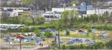  ??  ?? A homeless encampment off East 11th Street is seen Friday.