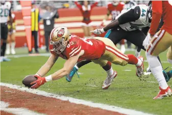  ?? Marcio Jose Sanchez / Associated Press ?? Niners tight end George Kittle dives for the end zone to complete an 8-yard touchdown reception that gave the team a 23-19 third-quarter lead that it would not relinquish.