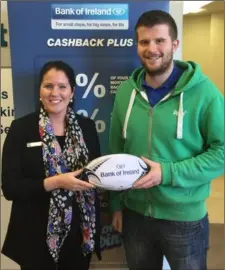  ??  ?? Lorraine Hayden, business advisor, Bank of Ireland New Ross, presenting a BOI branded official ball to Kieran Treacy of New Ross in advance of the Bank of Ireland Provincial Towns Cup match.