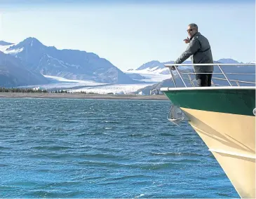  ?? THE NY TIMES ?? US President Barack Obama takes in melting glaciers during a tour of Kenai Fjords National Park in Alaska. He appeared in an episode of the survivalis­t reality show ‘Running Wild With Bear Grylls’.