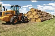  ?? DAVE KOLPACK / ASSOCIATED PRESS ?? Bales of hay that have been donated for a lottery drawing to help drought-stricken farmers and ranchers are stacked at a site near the North Dakota State University campus in Fargo, N.D.