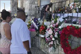  ?? RUSSELL CONTRERAS — THE ASSOCIATED PRESS ?? Mourners deliver flowers on Friday for the funeral in El Paso, Texas, of Margie Reckard, 63, who was killed by a gunman in a mass shooting earlier in the month.