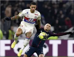  ?? AFP ?? Marco Verratti ( right) of PSG vies for the ball with Lyon’s Memphis Depay in their French League match at the Groupama Stadium on Sunday. Lyon won 2- 1. —