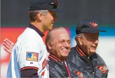  ?? BALTIMORE SUN FILE ?? Cal Ripken, left, Peter Angelos and then-Gov. William Donald Schaefer pose for a picture after throwing out the first pitch before opening day.