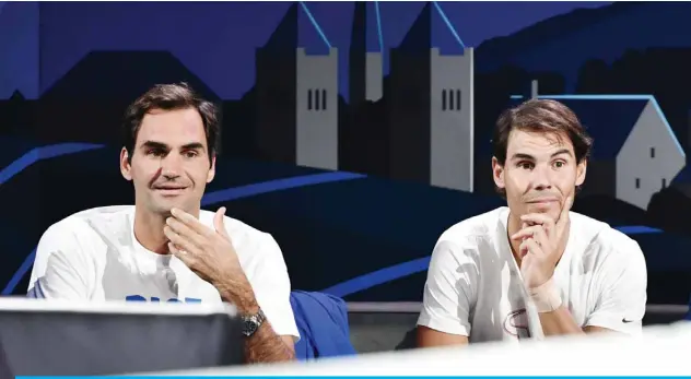  ?? — AFP ?? GENEVA: In this file photo taken on Sept 20, 2019, Team Europe’s Roger Federer (left) and teammate Rafael Nadal watch a match as part of the 2019 Laver Cup tennis tournament in Geneva.