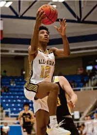  ?? ?? Ojani Bowen drives for two for Team Gold on Sunday. Ojani’s father, Bruce, served as Team Gold’s coach.