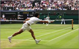  ?? CLIVE BRUNSKILL — GETTY IMAGES ?? Carlos Alcaraz of Spain plays a forehand in the men's singles final against Novak Djokovic of Serbia at the Championsh­ips Wimbledon at All England Lawn Tennis and Croquet Club on Sunday in London.
