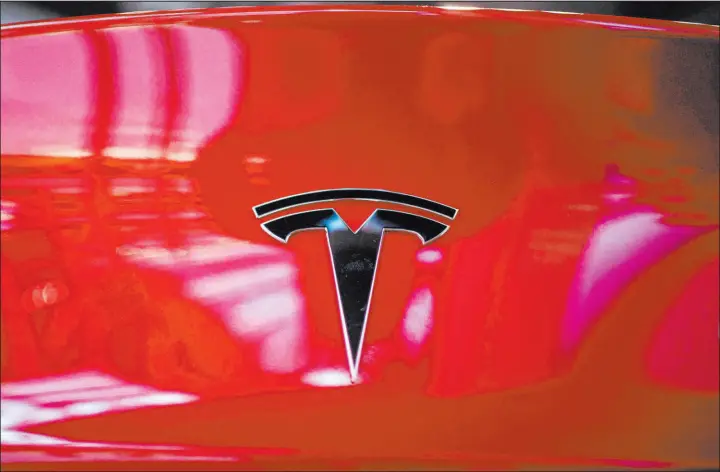  ?? Nicolas Asfouri Getty Images ?? The back of a Tesla car Model 3 is seen at a Tesla shop inside of a shopping Mall in Beijing on May 26, 2021.