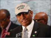  ?? Bob Andres / AJC via AP ?? Senator Lester G. Jackson dons a cap supporting the Girl Scouts as he speaks at a press conference in Atlanta on Monday.