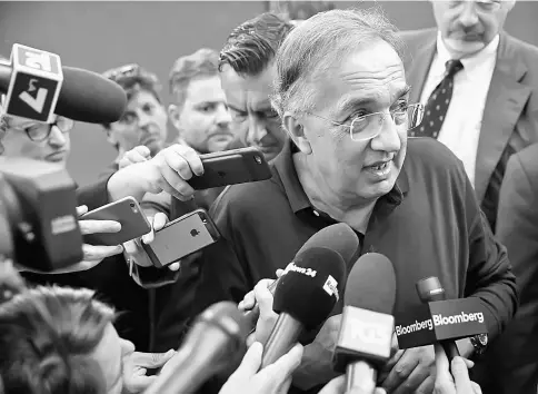  ?? — WP-Bloomberg photo ?? Marchionne, chief executive officer of Fiat Chrysler Automobile­s NV, speaks to members of the media before presenting an award at the Rotman European Trading Competitio­n (RETC) in applied finance hosted at Luiss Guido Carli University in Rome in August.