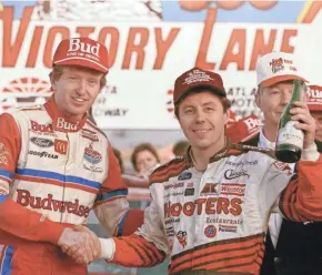  ?? ASSOCIATED PRESS ?? Hooters 500 winner Bill Elliott (left) celebrates with NASCAR Winston Cup champion Alan Kulwicki following the race at Atlanta Motor Speedway in Hampton, Ga., in 1992.