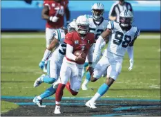  ?? Brian Westerholt / Associated Press ?? Arizona Cardinals quarterbac­k Kyler Murray runs away from Carolina Panthers defensive end Marquis Haynes last Sunday.