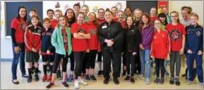  ??  ?? Author Patricia Polacco, center, with a group of students from North Coventry Elementary School.