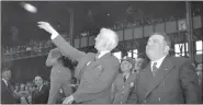  ?? THE ASSOCIATED PRESS ?? Commission­er Kenesaw Mountain Landis throws out the first ball, formally opening the 1941World Series between the Yankees and Brooklyn Dodgers at Yankee Stadium in New York. New York Mayor Fiorello La Guardia is at right.