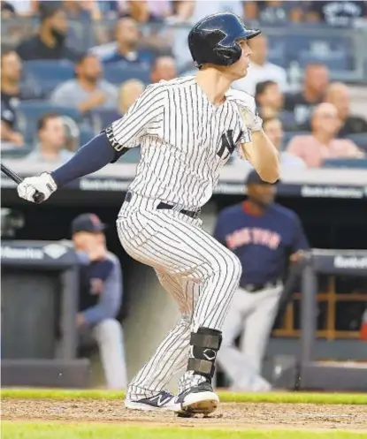  ?? GETTY ?? Greg Bird follows through on the first of his two home runs Friday night. Aaron Boone has a decision to make today.