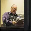  ?? RIC ERNST/PNG ?? A B.C. conservati­on officer carries a stack of files at the Vancouver offices of Imperial Metals on Tuesday.