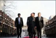  ?? AP/MARK WILSON ?? Defense Secretary Chuck Hagel (right) reviews an honor guard Saturday with Afghan President Ashraf Ghani (center) during an arrival ceremony at the presidenti­al palace in Kabul.