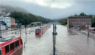  ?? DEUTSCHE BAHN ?? Stranded and partially submerged DMUs at Gerolstein, in the Eifel region of Germany, where the River Kyll had overwhelme­d the railway.