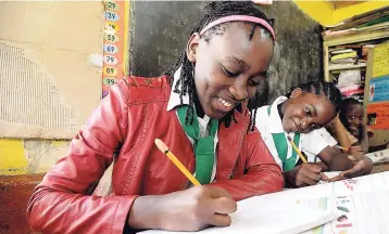  ?? PHOTO BY LIONEL ROOKWOOD ?? Grade five students doing classwork at Eccleston Primary School, St Catherine.