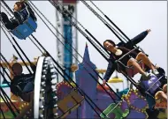  ??  ?? A rider on the Sea Swings exults at the Santa Cruz Beach Boardwalk on May 29, 2019. Some of the site’s rides will again be open to the public starting this week.