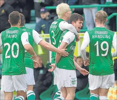  ??  ?? n Hibernian striker Sam Stanton is congratula­ted by his team-mates after scoring an early goal.