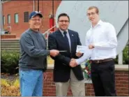  ?? SUBMITTED PHOTO ?? With the Veterans Memorial in the background at First Energy Stadium, Reading, Jeremy Fees (center), Chief of Voluntary Services for Lebanon VA Medical Center accepts checks totaling $1,100from Tony Santay, (left) All Star game chairman and Steve...