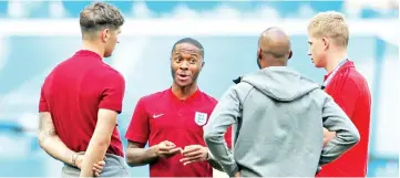  ?? — Reuters photo ?? (From left) England’s John Stones, Raheem Sterling and Fabian Delph with Belgium’s Kevin De Bruyne on the pitch before the World Cup play-off for third place match at the Saint Petersburg Stadium in this July 14 file photo.