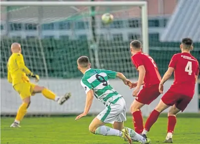  ?? ?? Joshua Peters (No. 9) opens the scoring for Buckie Thistle at home to Lossiemout­h