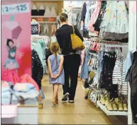  ??  ?? Madeleine Mitchell and her daughter Lily, 6, both of Livermore, shop for back-to-school clothes at Stoneridge.