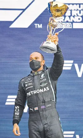  ?? Picture: AFP ?? TON-UP. Mercedes’ British driver Lewis Hamilton celebrates on the podium after winning the Russian Formula One Grand Prix at the Sochi Autodrom yesterday.