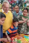  ?? — PTI ?? Author Ruskin Bond celebrates his birthday by cutting a cake with children at Cambridge Bookstore in Mussoorie on Saturday.