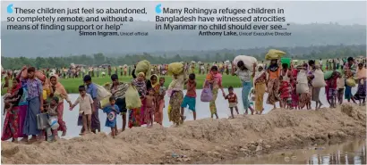  ?? AP ?? Rohingya Muslims, who spent four days in the open after crossing over from Myanmar into Bangladesh, carry their belongings after they were allowed to proceed towards a refugee camp in Palong Khali, Bangladesh, on Thursday. —