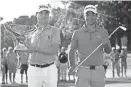  ?? BUTCH DILL/USA TODAY SPORTS ?? Justin Thomas hoists the trophy after winning the FedEx Cup while Xander Schauffele holds Calamity Jane, a replica of Bobby Jones’ putter, after winning the Tour Championsh­ip on Sunday.