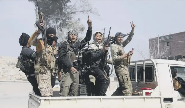  ??  ?? 0 Turkish-backed Syrian rebels celebrate in Afrin yesterday after seizing the town centre as they made rapid gains in their campaign against Kurdish forces, who had fled