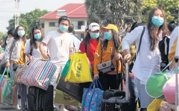  ??  ?? HOMEWARD BOUND: Some of the 137 of returnees from Wuhan, the epicentre of the Covid-19 outbreak, leave the first state quarantine facility, at Sattahip naval base in Chon Buri on Feb 19.