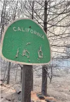  ?? TREVOR HUGHES/USA TODAY NETWORK ?? Heat from the Creek Fire melted the lettering off this roadside sign near Shaver Lake, Calif.