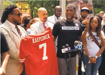  ?? Ralph Russo / Associated Press ?? Supporters of Colin Kaepernick, who protested systemic racism before his football games, speak at a rally outside NFL headquarte­rs in New York in May.