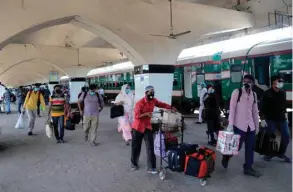  ??  ?? City dwellers arrive by a train after the government-imposed lockdown as a preventive measure against the coronaviru­s (Covid-19) ended, in Dhaka yesterday.
