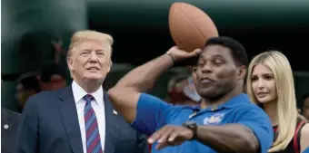  ?? AP file ?? ON THE FIELD: Herschel Walker throws a football at the White House in 2018 in front of then-President Donald Trump and his daughter Ivanka.