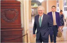  ?? ALEX BRANDON/ASSOCIATED PRESS ?? Senate Majority Leader Mitch McConnell of Ky., left, walks out of his office on Capitol Hill, Wednesday in Washington.