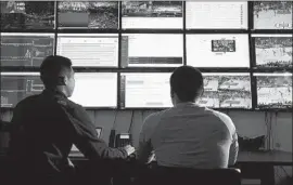  ??  ?? SOFTWARE engineer Jonathan Huang, left, and producer Alvin Anol watch a Clippers game in the control room of Second Spectrum in Los Angeles.
