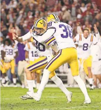  ?? MARVIN GENTRY/USA TODAY SPORTS ?? LSU kicker Drew Alleman celebrates with Brad Wing after Alleman kicked the game-winning field goal in overtime in 2011.