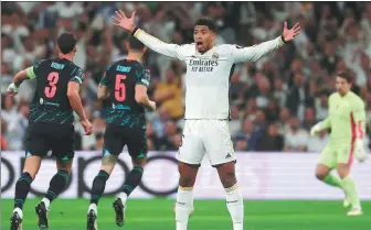  ?? AFP ?? A stunned Jude Bellingham reacts to Bernardo Silva’s opening goal for Manchester City during Tuesday’s Champions League quarterfin­al first leg at the Santiago Bernabeu Stadium.